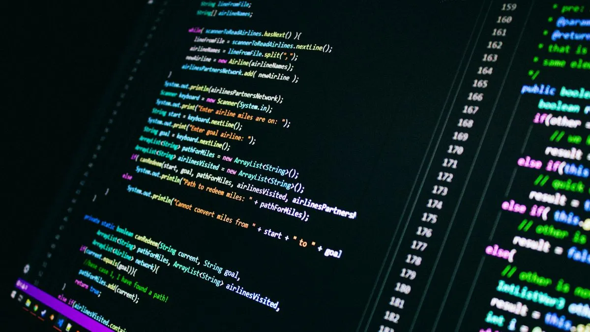 How AI Stock Screeners Are Changing Value Investing A computer screen displays colourful lines of program code against a dark editor background.