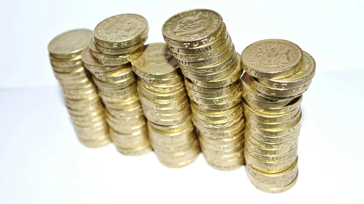 Dollar-Cost Averaging Explained (with Example) A stack of coins growing taller, a fixed sum invested at regular intervals buys more shares when prices are low and fewer when they are high