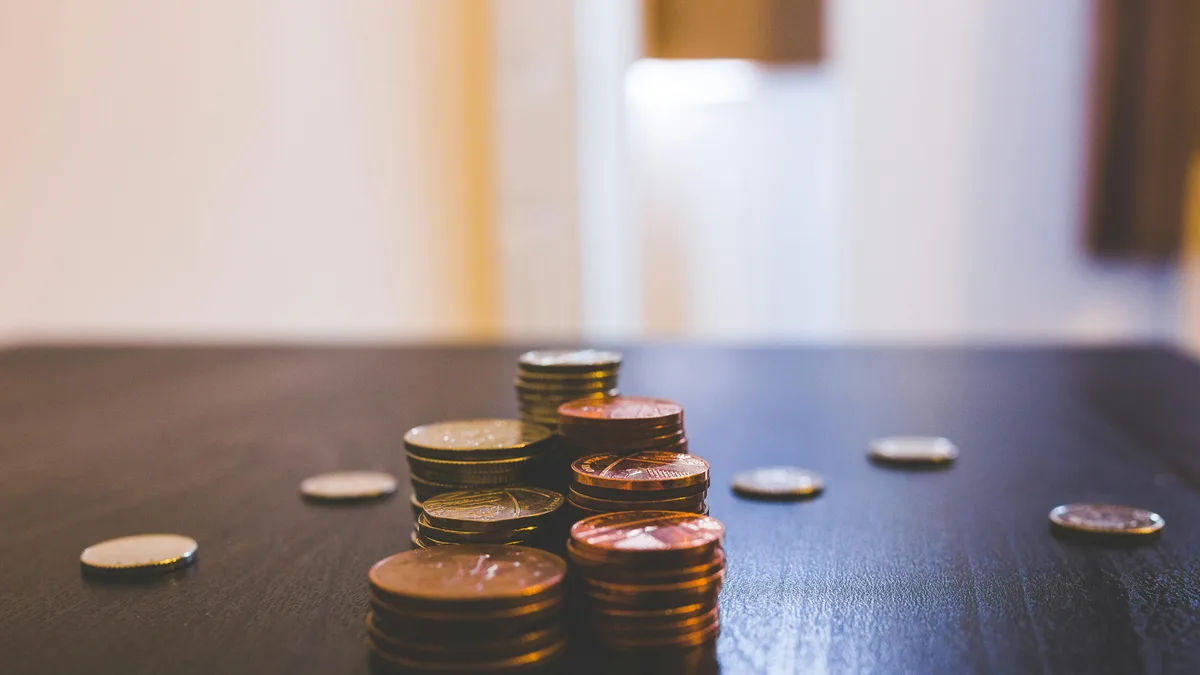 High-Yield Savings vs Fixed Deposits: Where to Park Cash An open savings jar beside a calendar, instant-access savings can be tapped on any day, the hallmark of an emergency fund