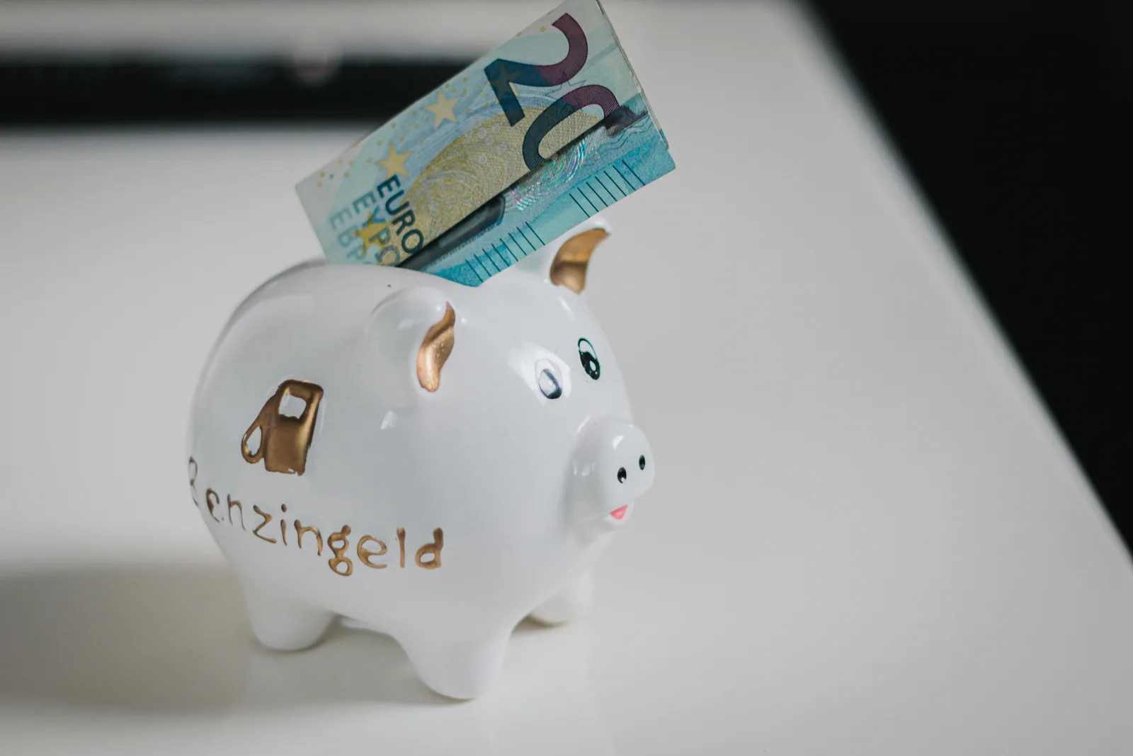 What Is WACC? A Plain-English Guide to the Weighted Average Cost of Capital A piggy bank with a banknote being deposited — a simple picture of company funding, the equity-and-debt mix that the weighted average cost of capital blends together